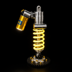 LuxShock coilover desk lamp switched on, lit in warm amber